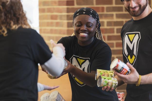 Manchester students collect cans during U Can Crush Hunger.