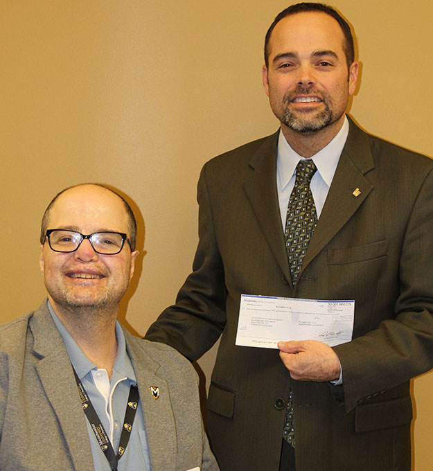 Randy Jennings, right, presents $8,000 to  W. Thomas Smith, dean of Pharmacy Programs at Manchester.