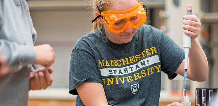 A Manchester University student measures carefully