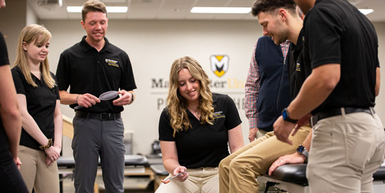Inside the DPT lab at MU students take turns practicing a new skill