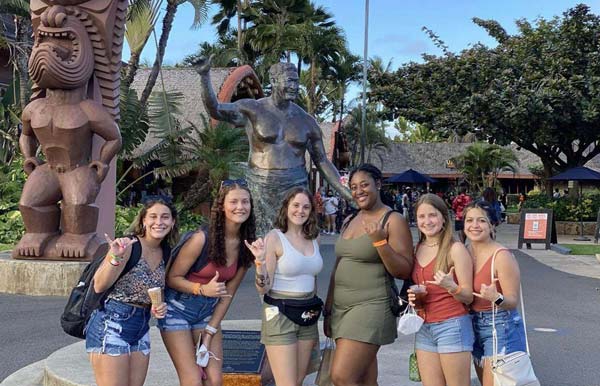 Students stand in front of the Polynesian Cultural Center