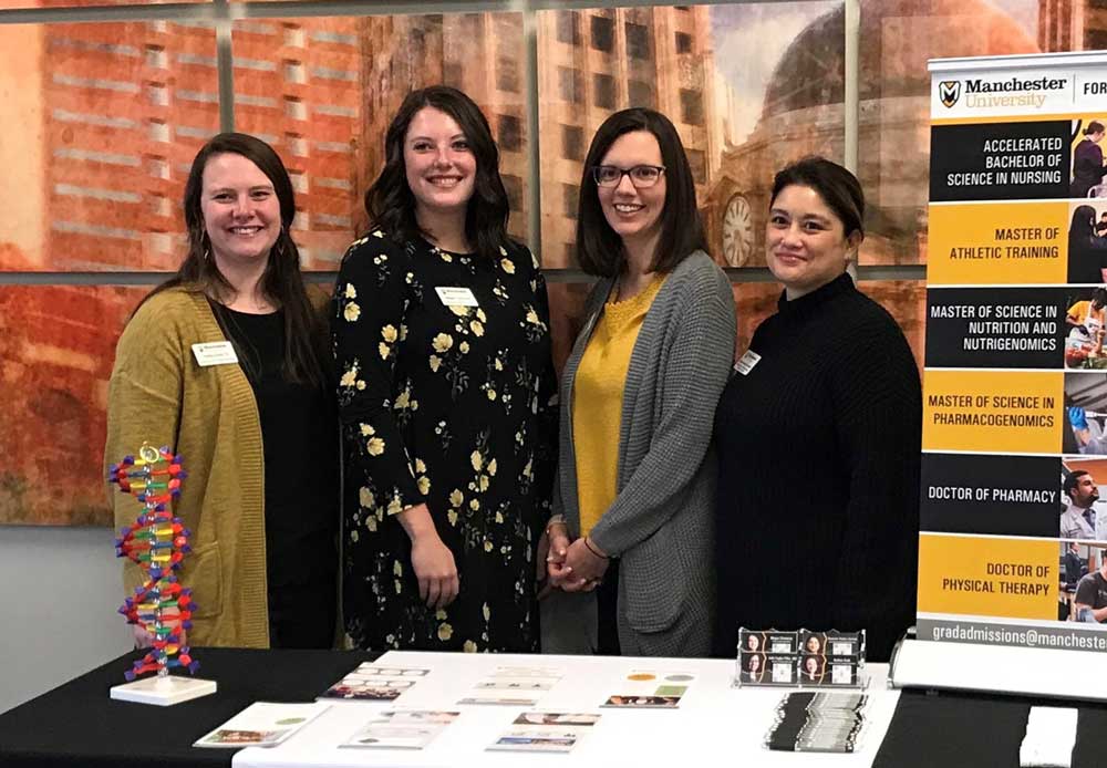 Office of Graduate Admissions staff together at a recruitment event