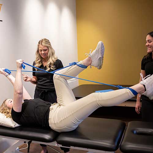 Students practice physical therapy using bands