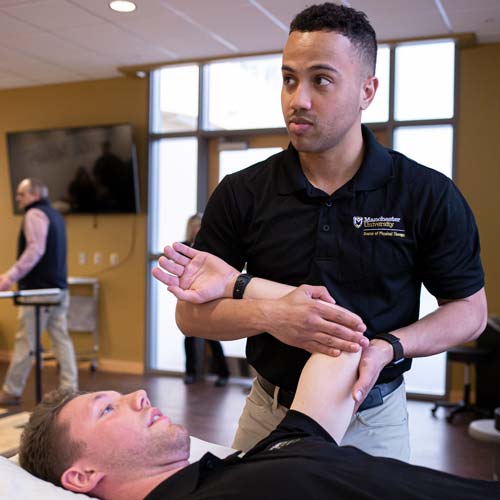 A student rehearses an adjustment within the DPT program