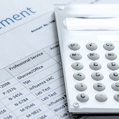 Image of a calculator resting on a billing statement
