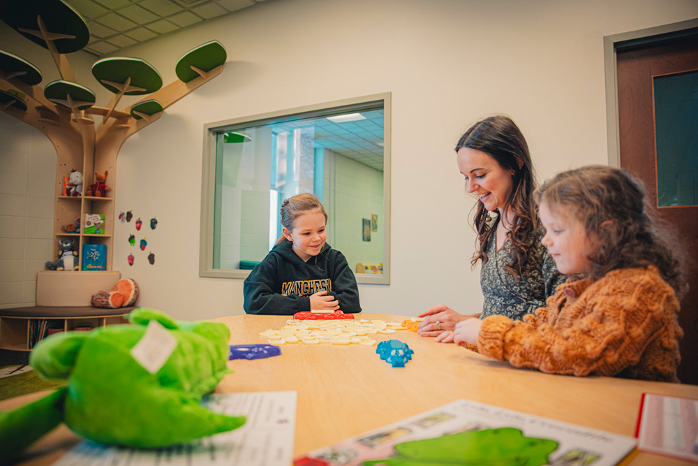 MU student interacts with young children in the Literacy Lab at MU
