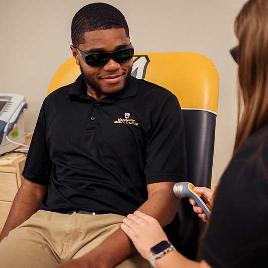 A student wears safety glasses during a practice examination