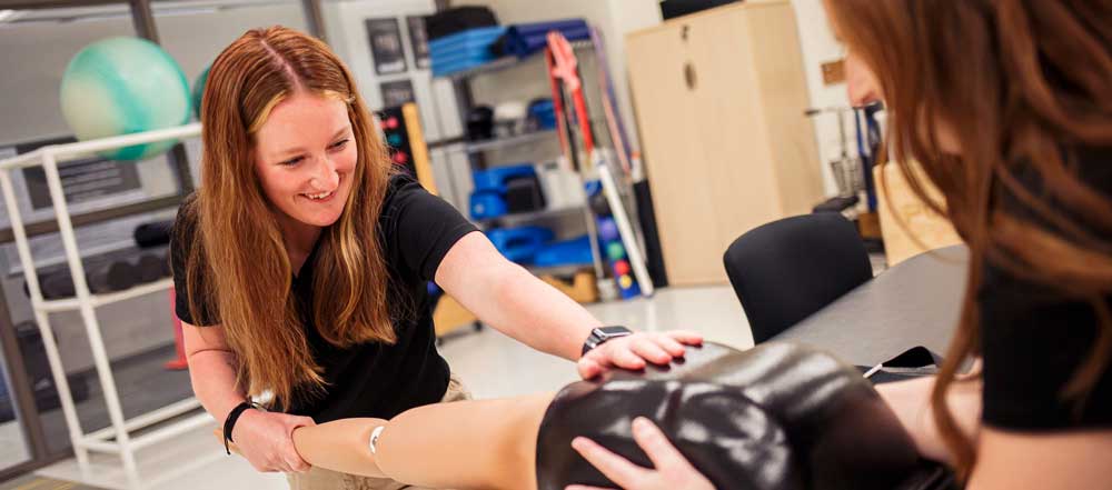 students practice on a lab arm