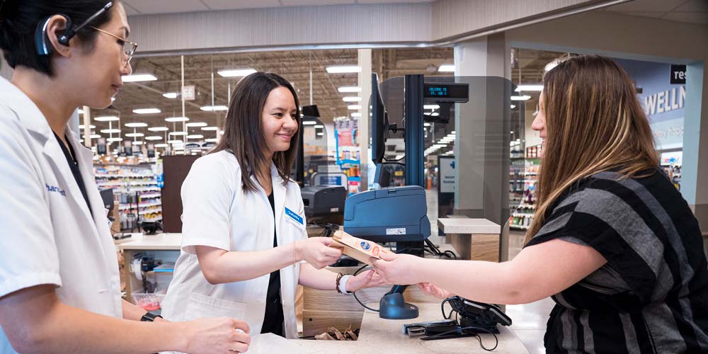 View all available scholarship at MU's Pharmacy Program. Photo displays a student working in a local pharmacy.