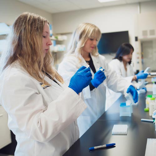 Opportunities in PGx - Image of students measuring ingredients.