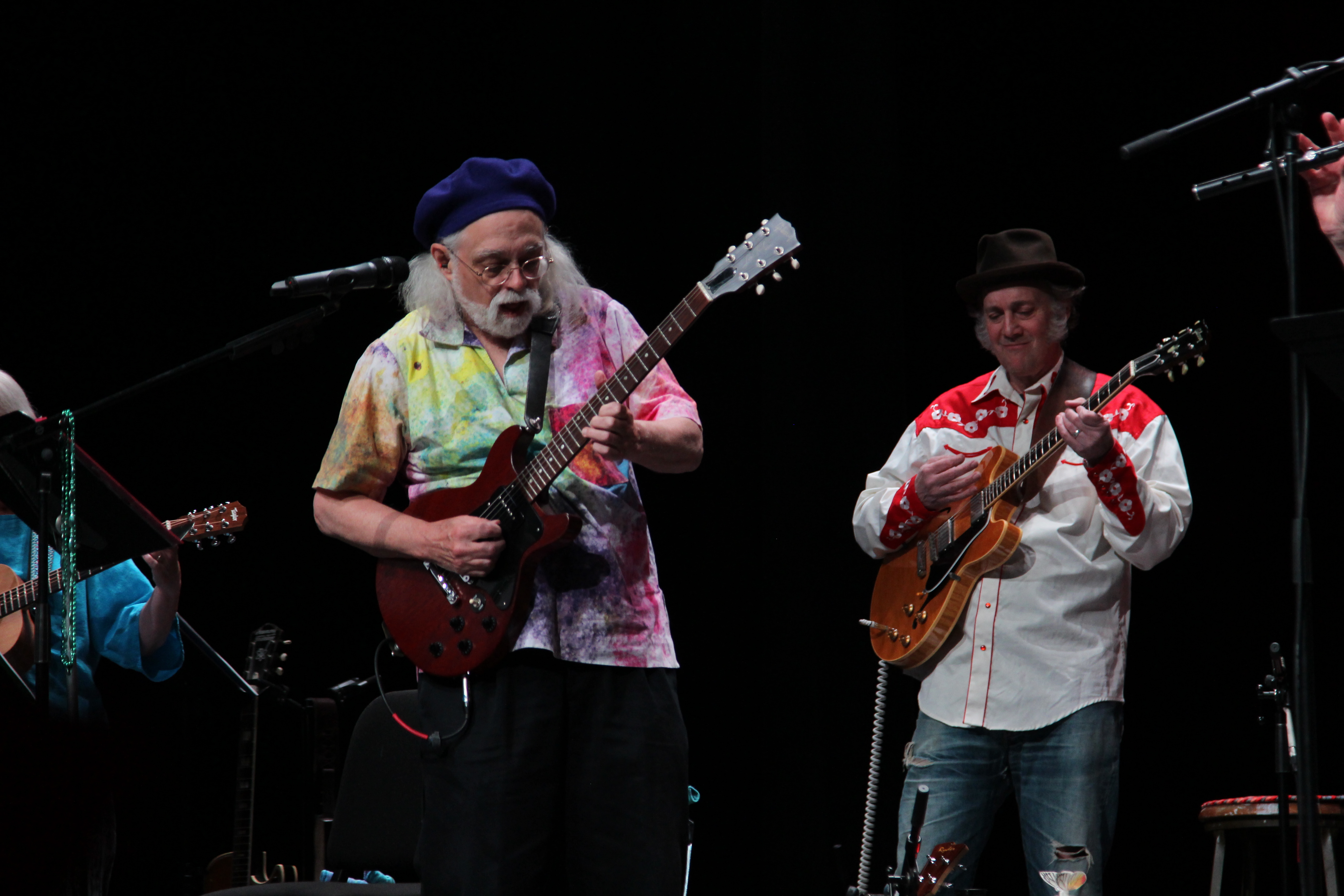 2 professors from MU play guitar on stage