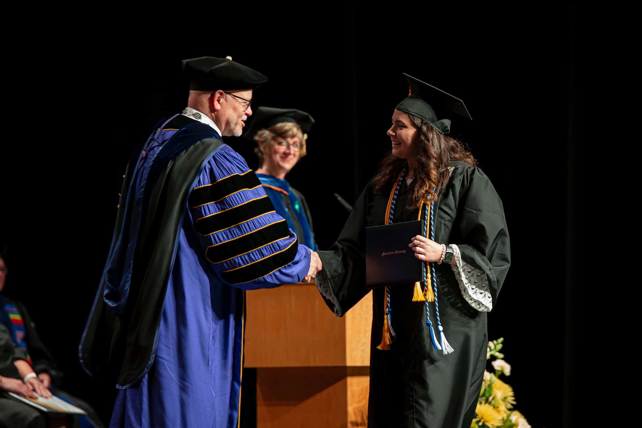 Commencement students walking on stage