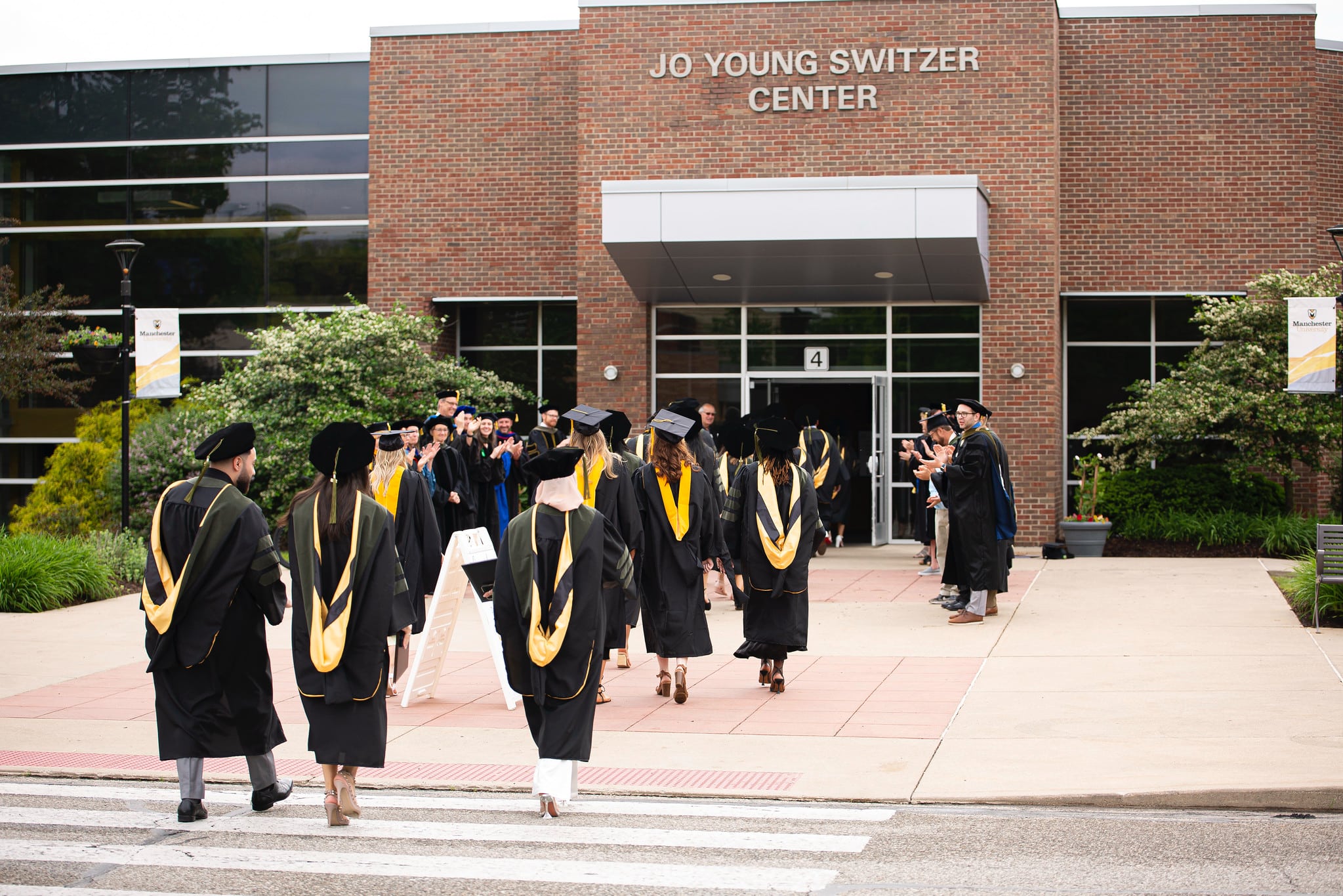 Commencement students walking into Jo Young Switzer Center