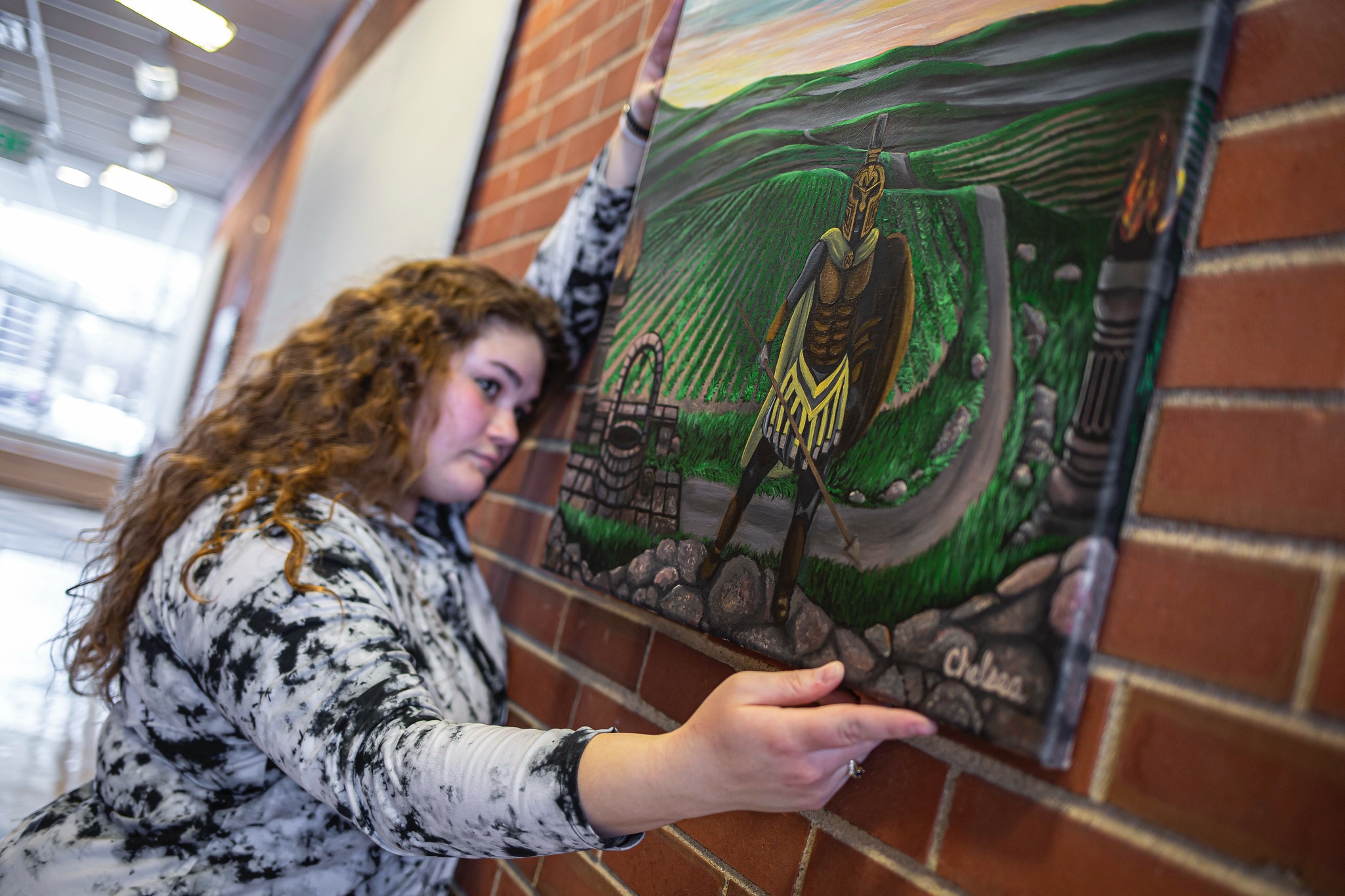 art student hanging drawing