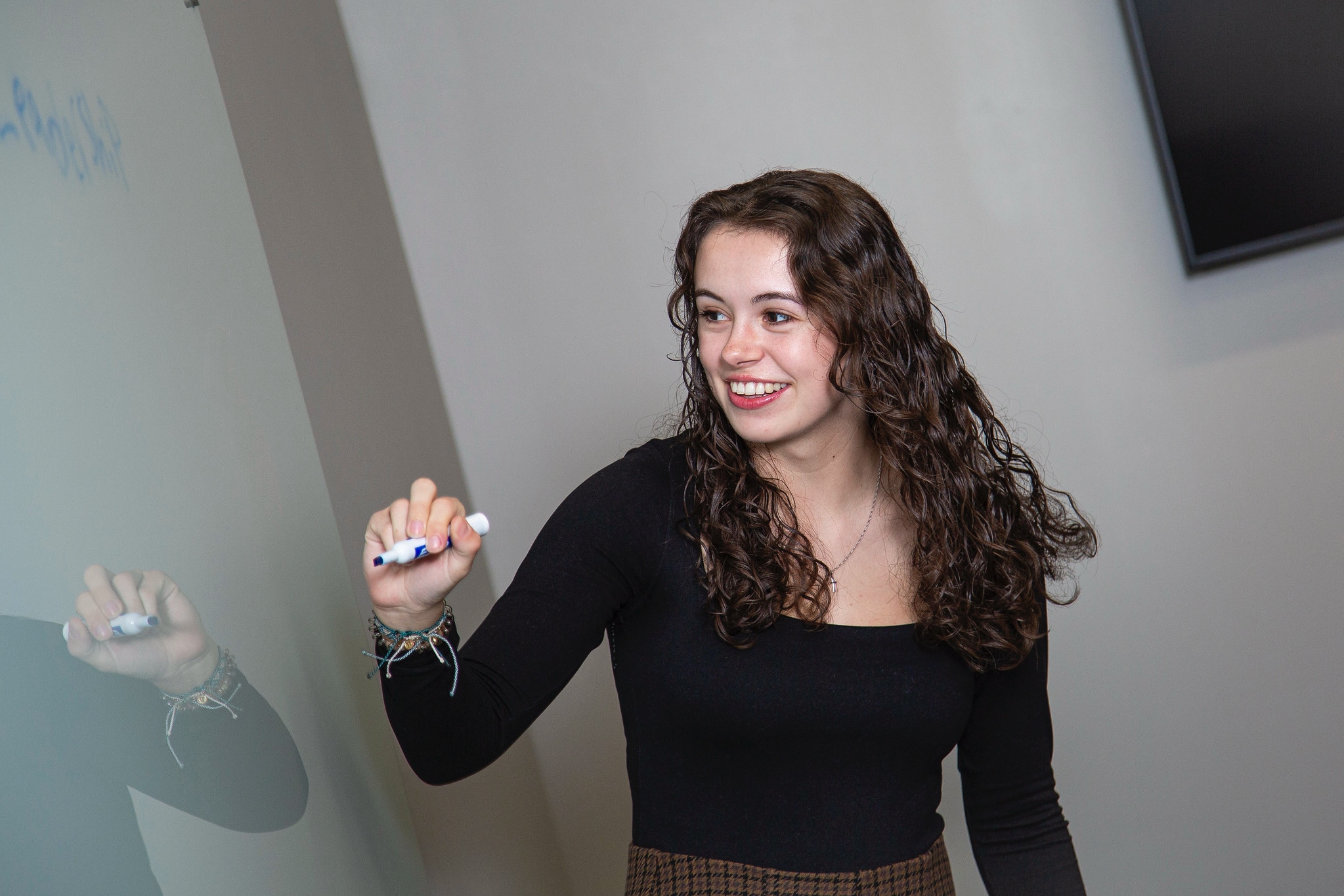 business student at board with blue marker