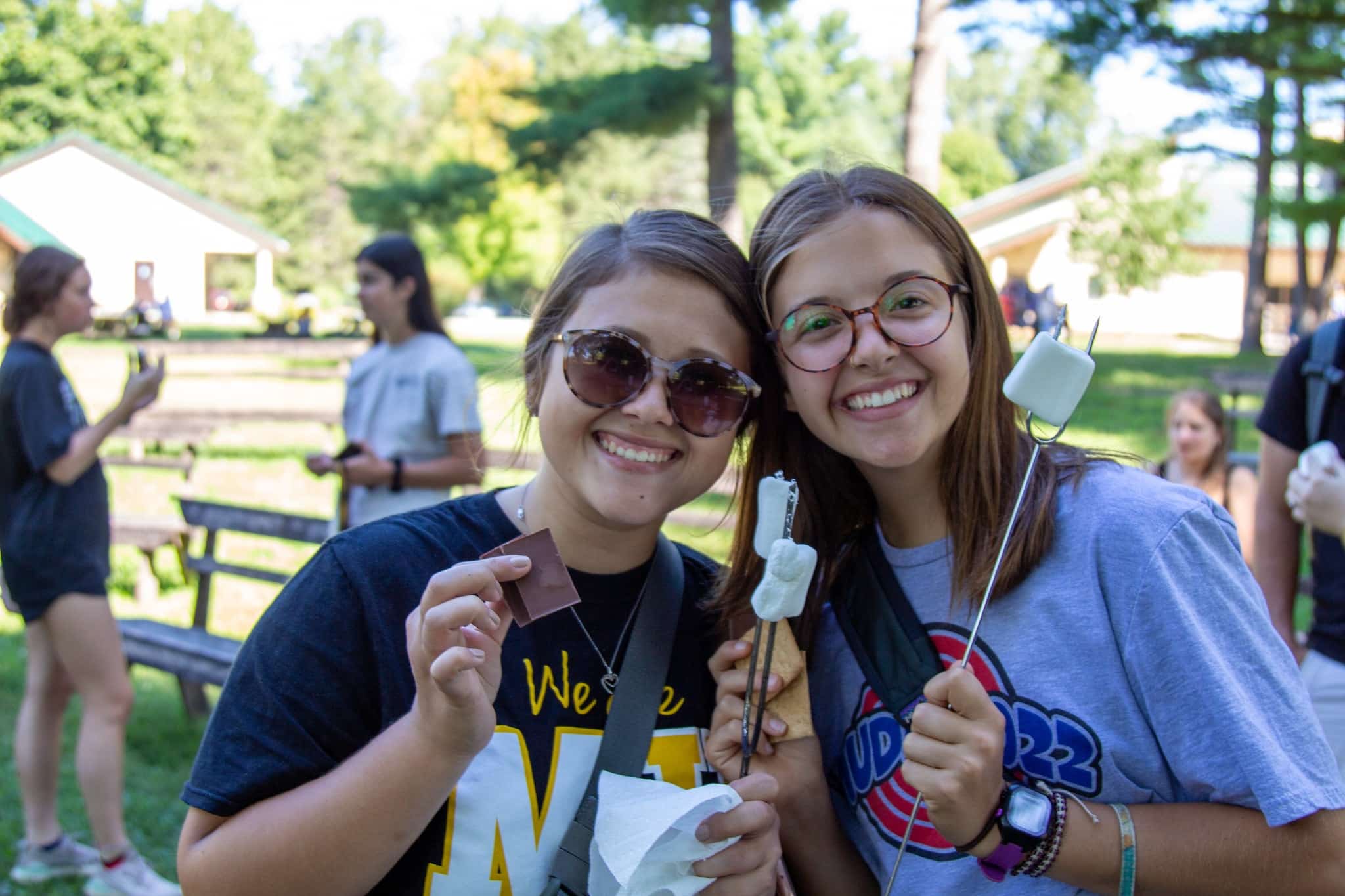 Camp Mack Day with 2 female students making smores