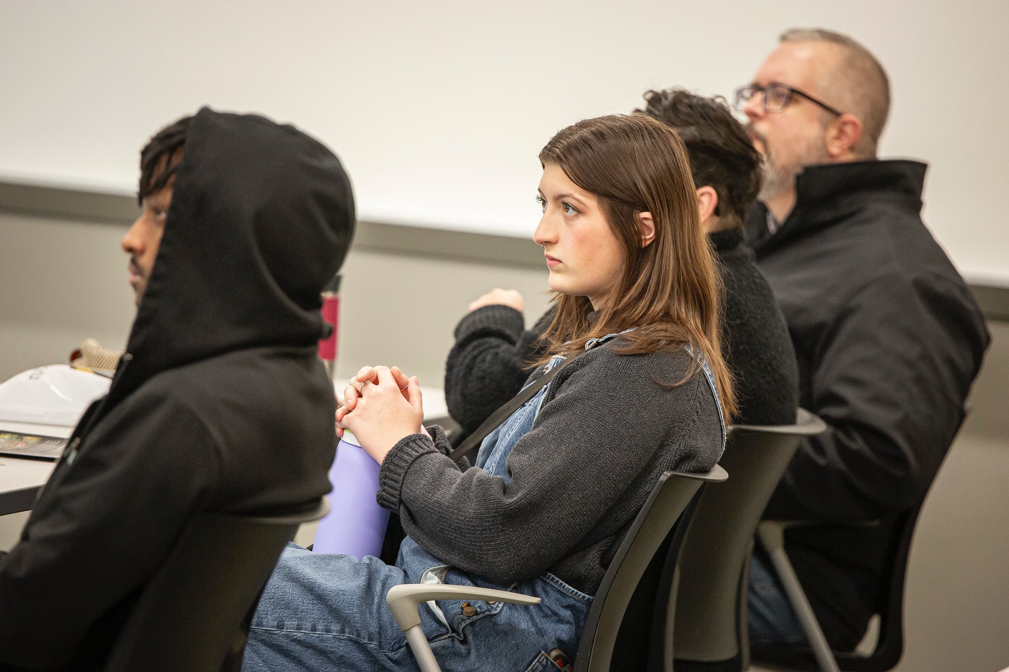 student listening in a classroom on a visit day