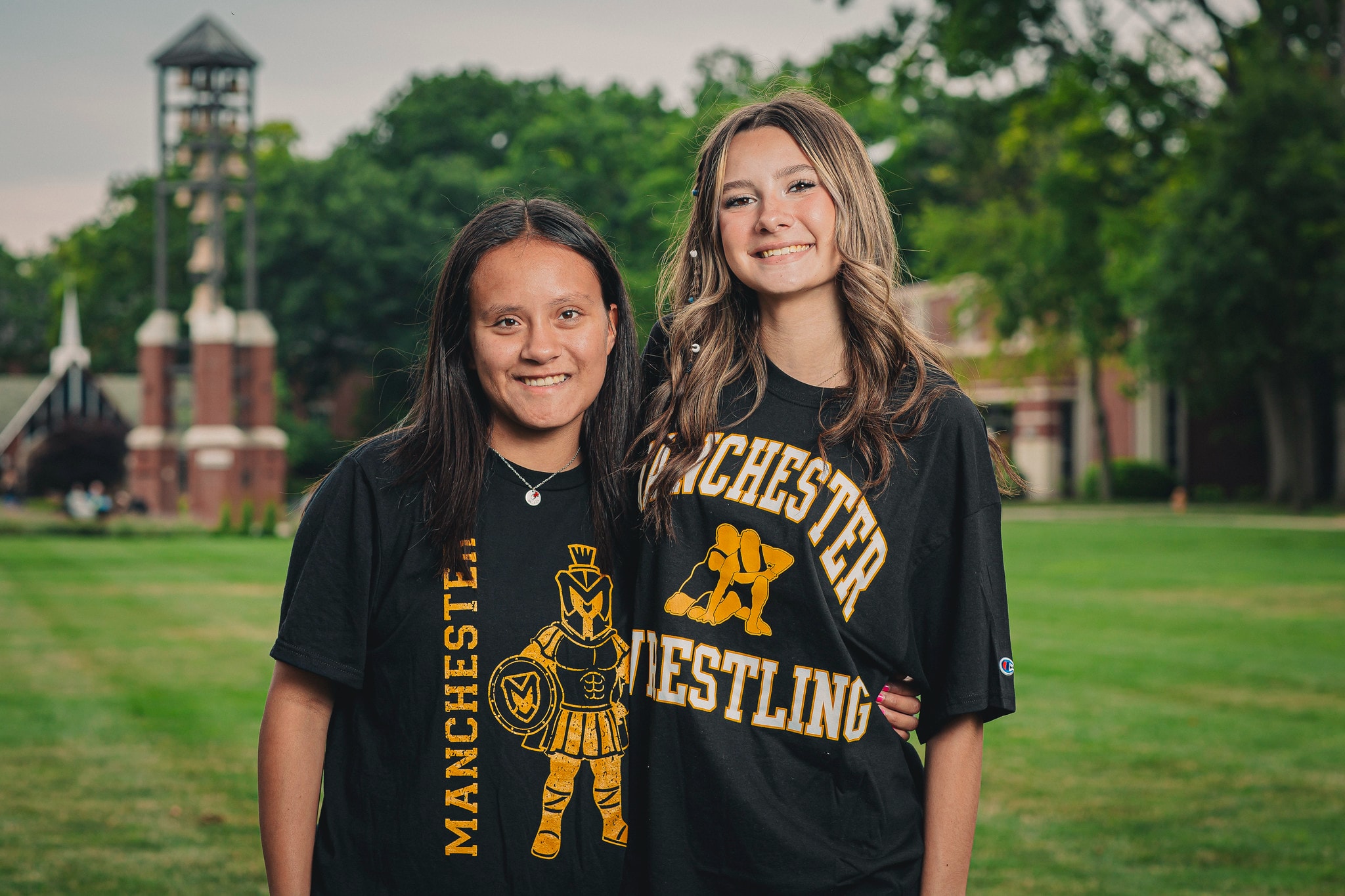 two females students outside with manchester tshirts
