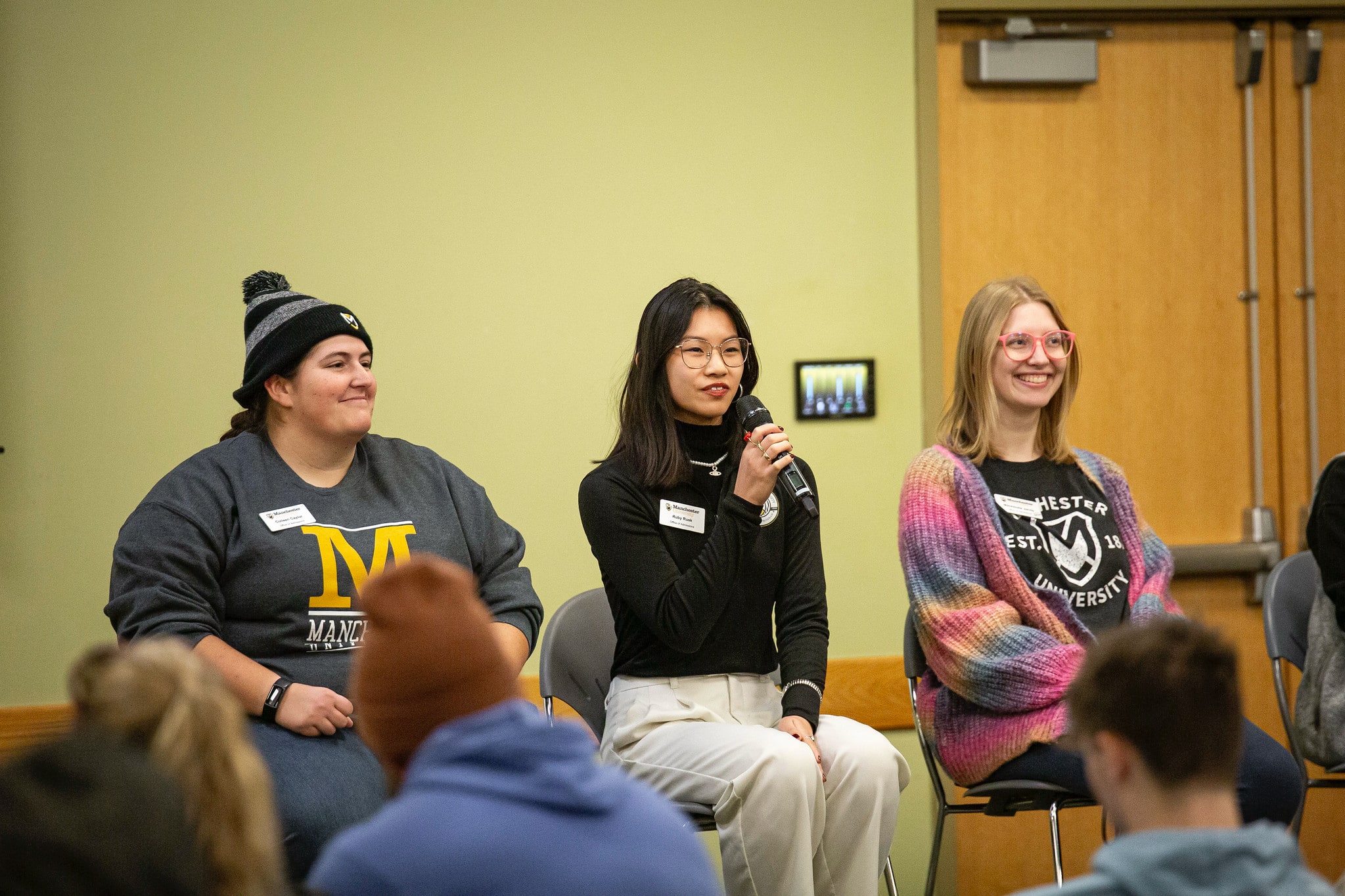students on a panel sitting down talking on a visit day