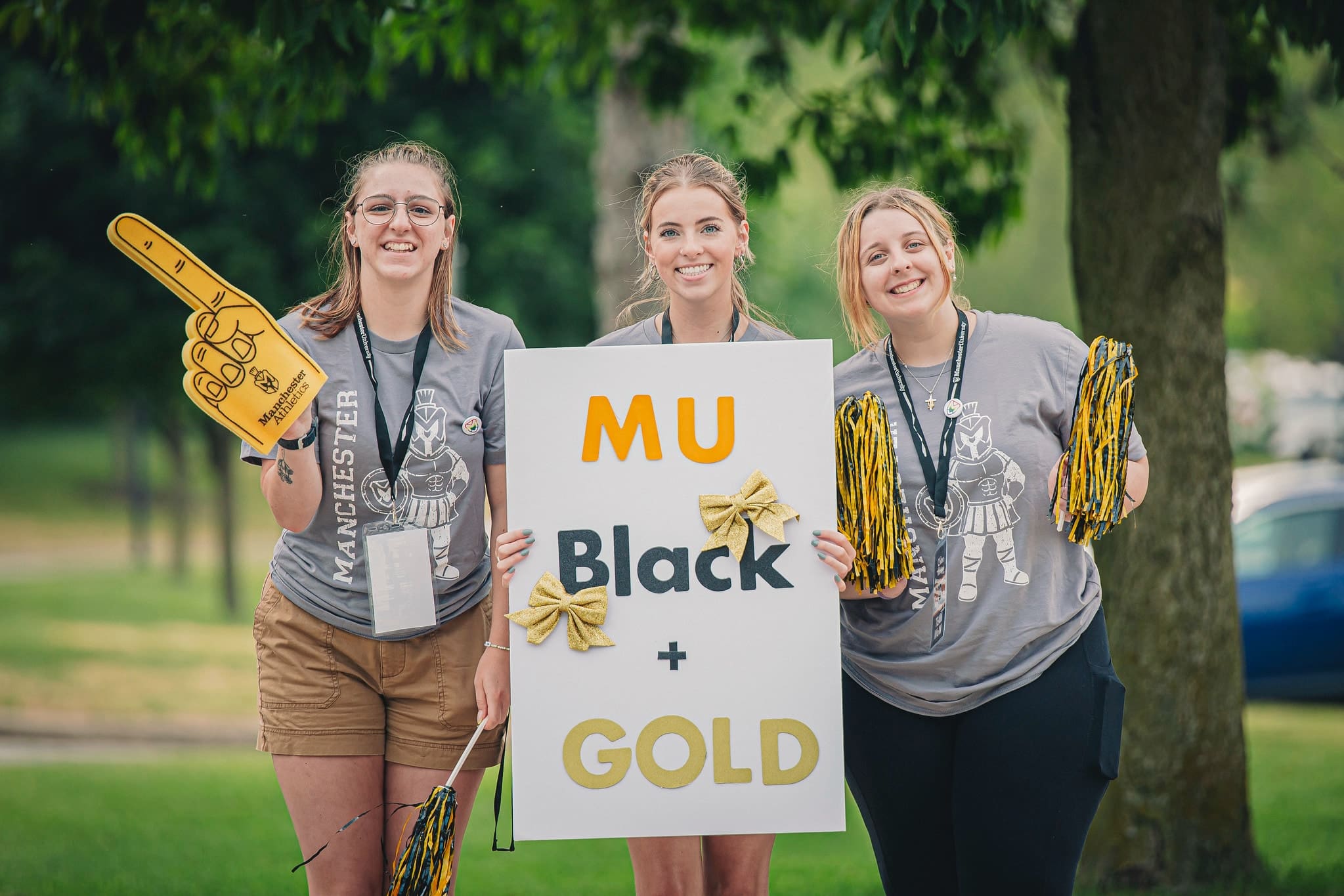 Campus Visit Day Black and Gold students holding sign