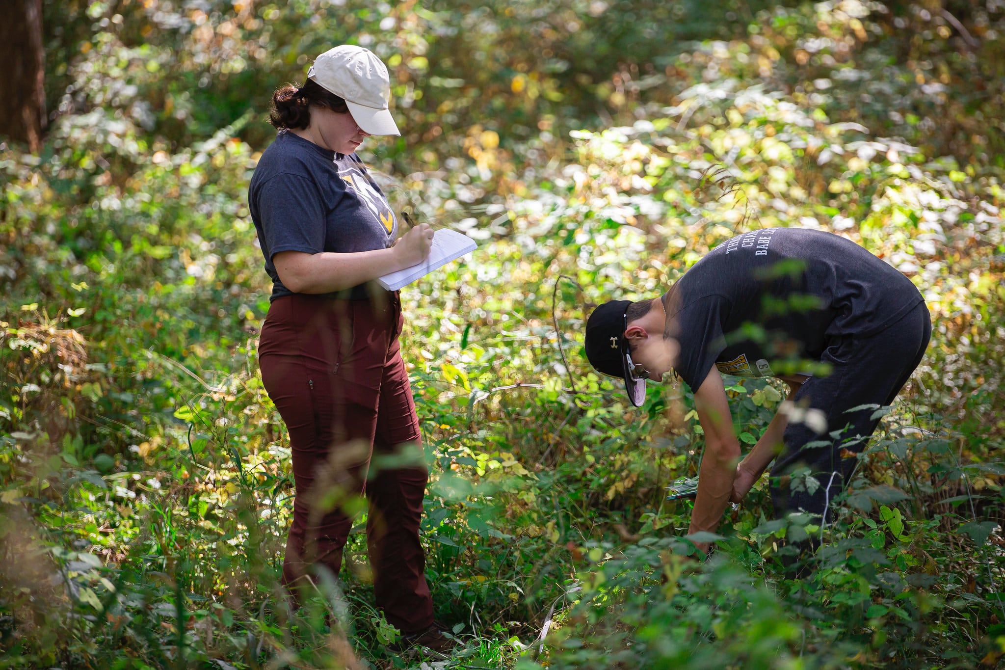 Environmental Studies students outside taking notes