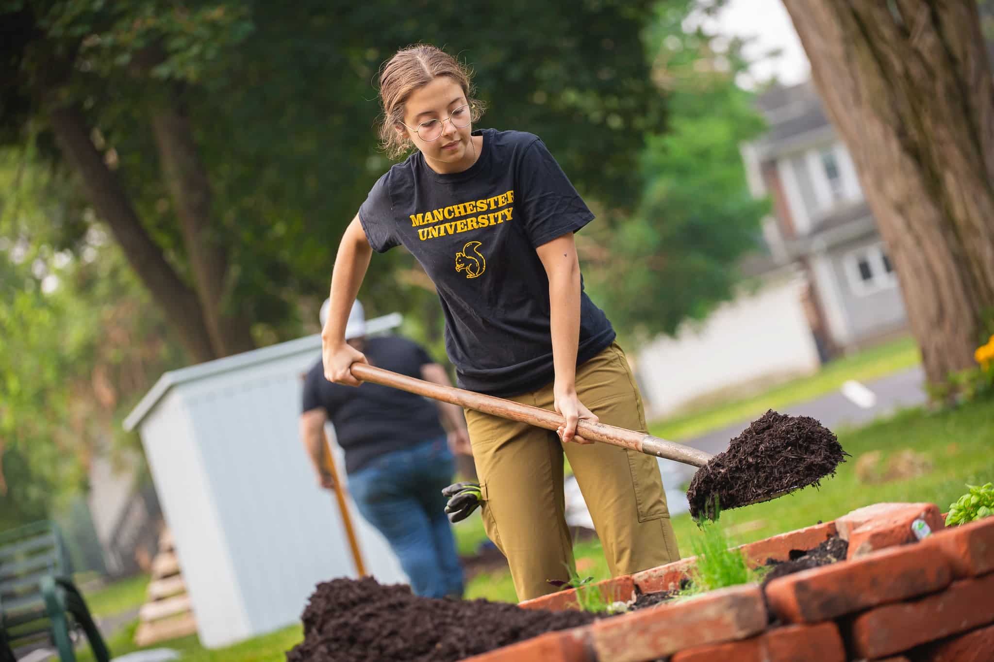 Environmental Studies student shoveling dirt