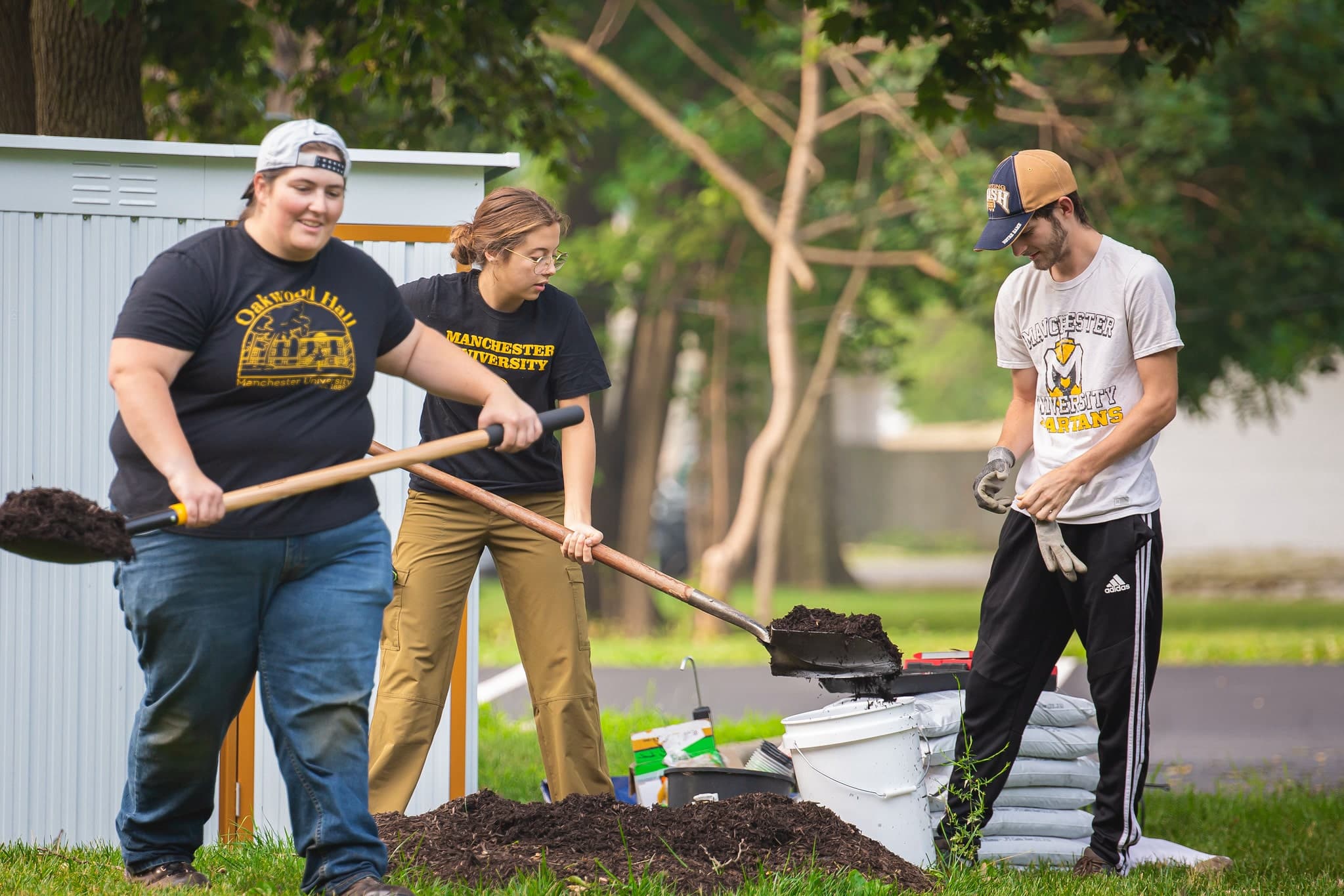 Environmental Studies students outside shoveling