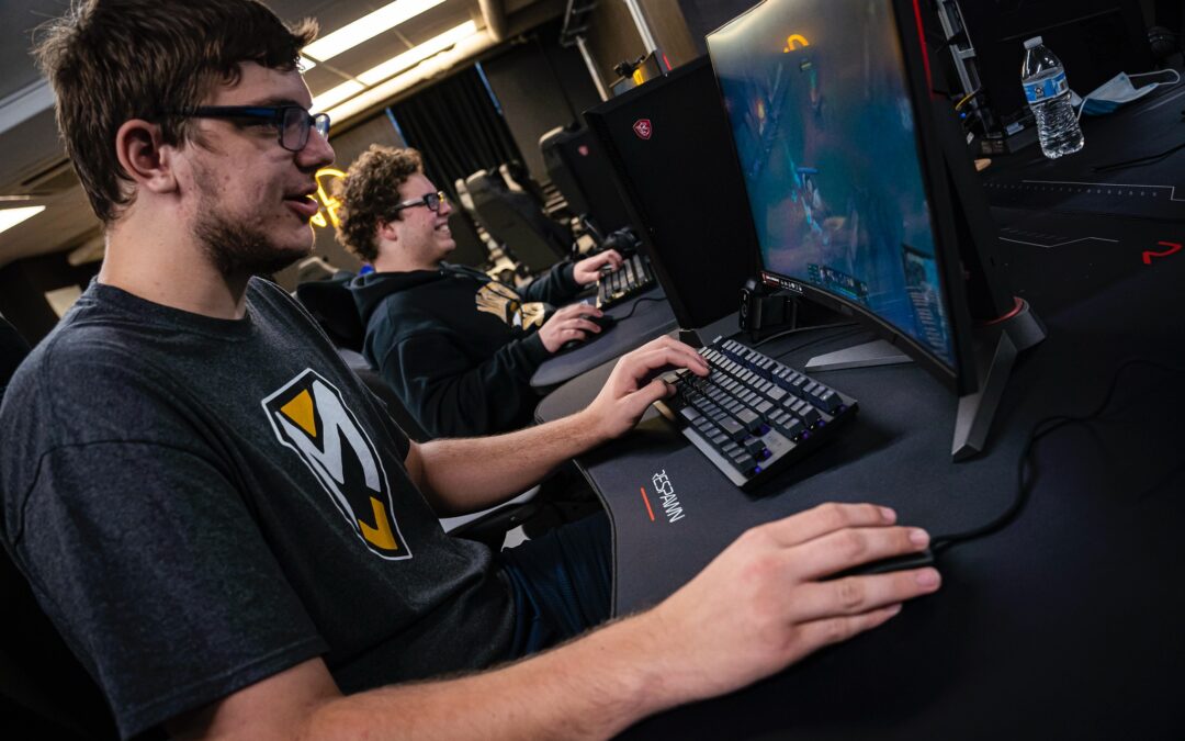 2 students playing computer games in an esports league