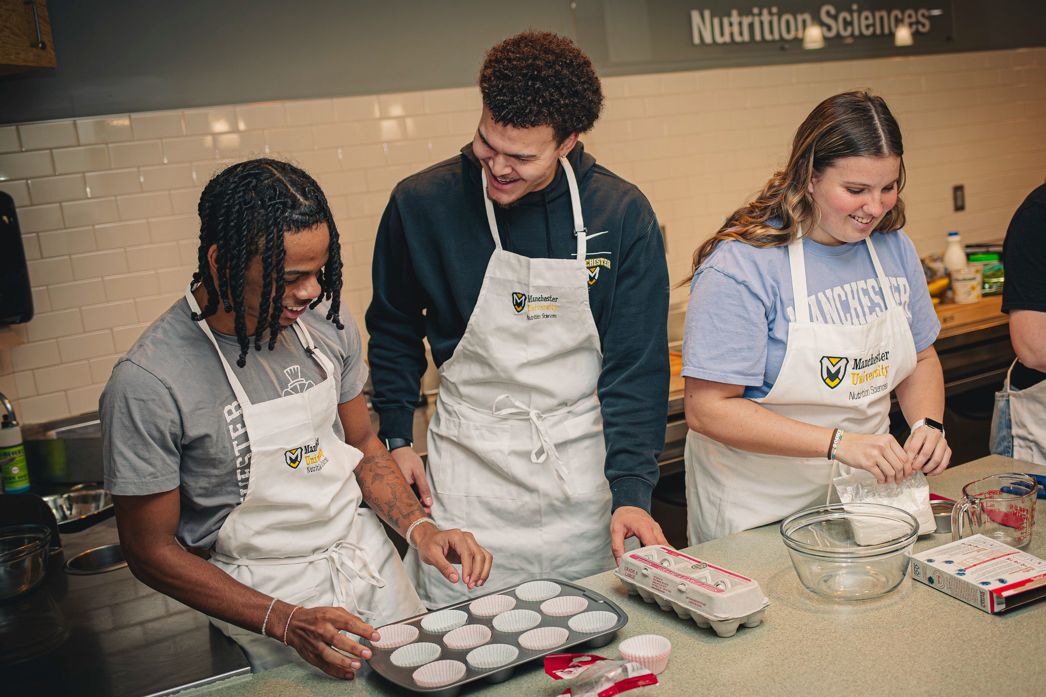a group of students prepare food during a nutrition class