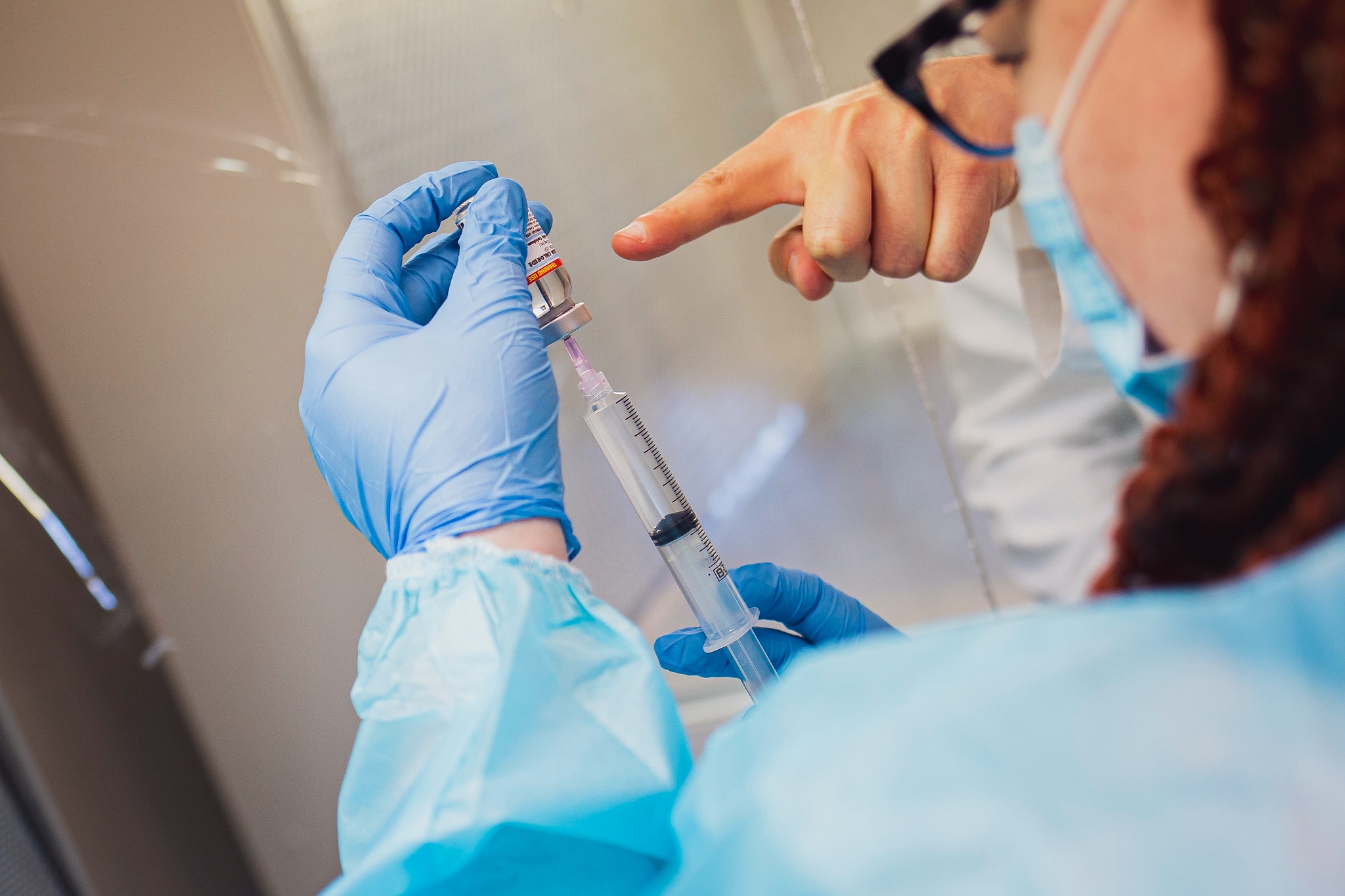 a female pharmacy student measures a dose of medication