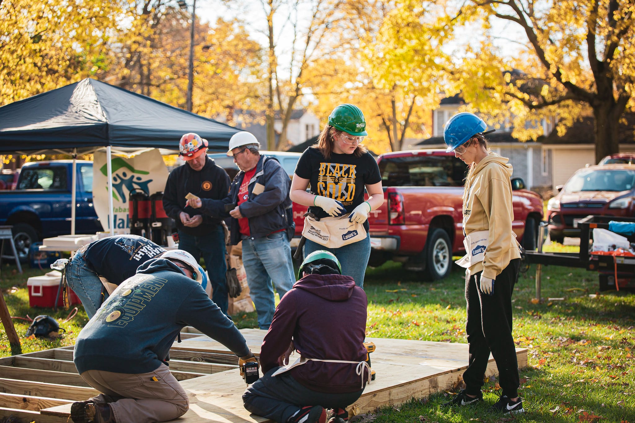 a group of manchester students do a service project with habitat for humanity