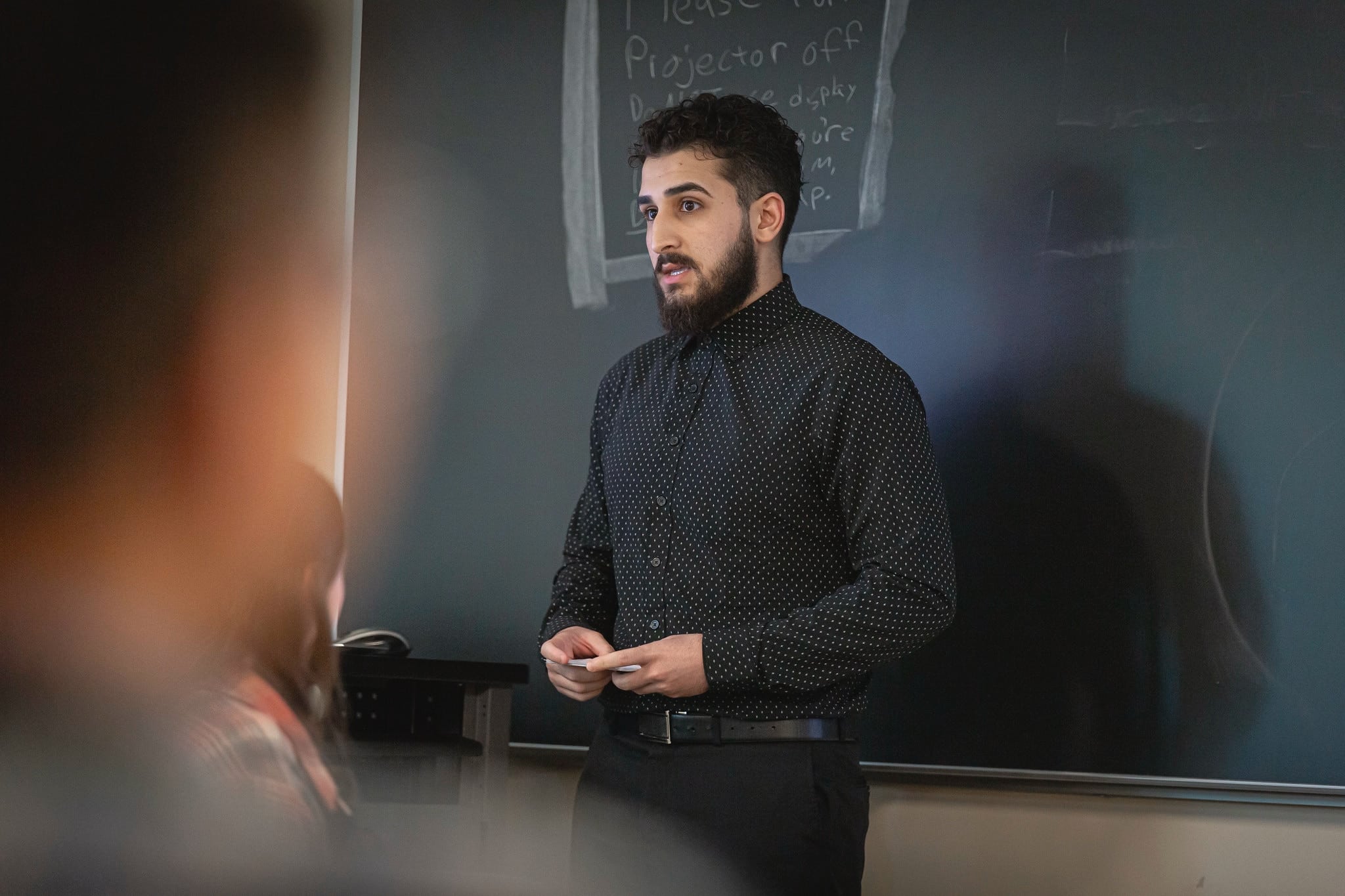 student inside of a classroom giving a presentation