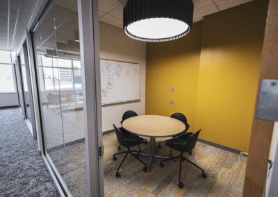 Office space with dry erase board, table, and chairs at the Fort Wayne Campus