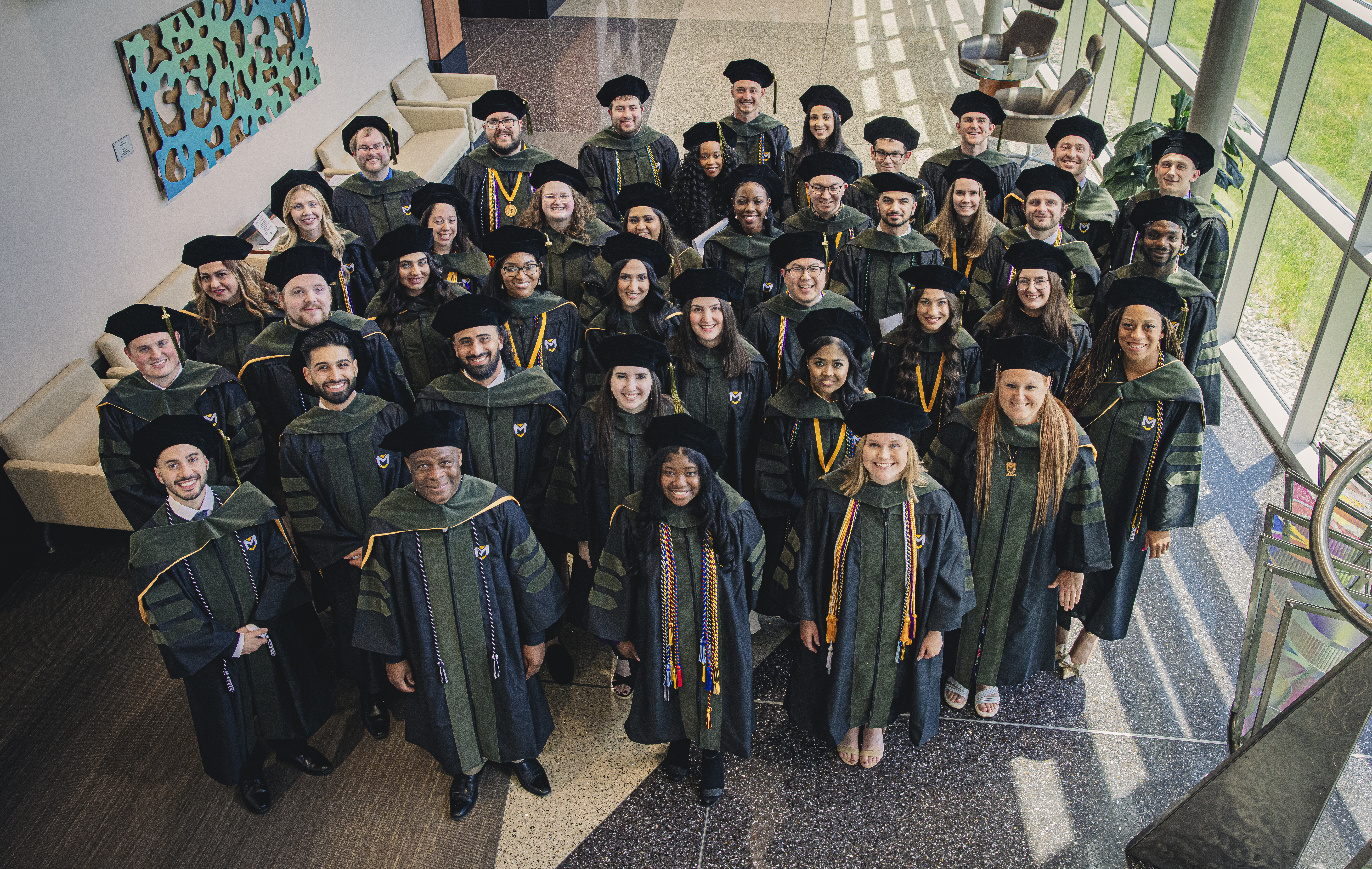 54551547333_b36cbc9e49_o Group of Manchester University graduates in black and green academic regalia