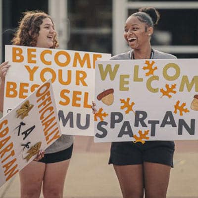Campus Visit Black and Gold Days Students holding Welcome Spartan signs