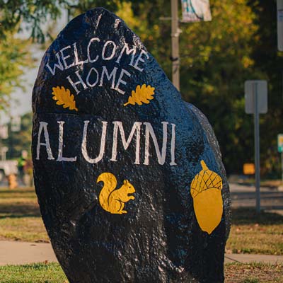 The MU Rock is painted and reads Welcome Home Alumni