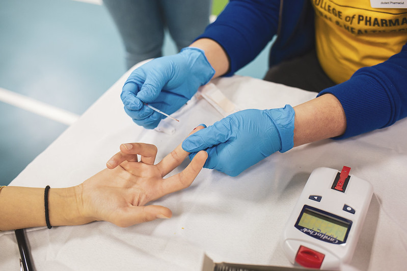 student performing finger stick for a1c testing