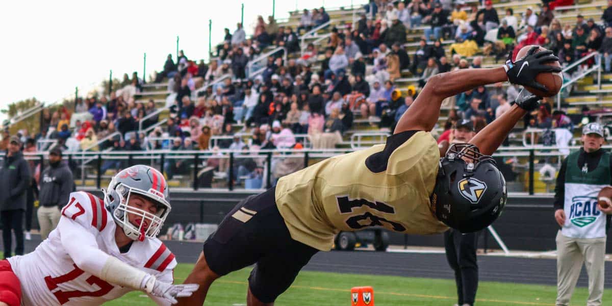 MU Spartan Wide Reciever catches the football in a dive over the endzone. 