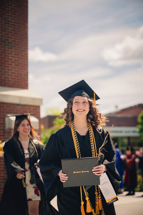 chimeHonorsGrad A female graduate walks proudly through the Manchester University Chime after receiving her Honors diploma.