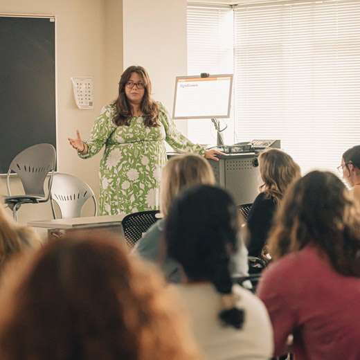 During the Student Research Symposium, students are engaged in a classroom discussion