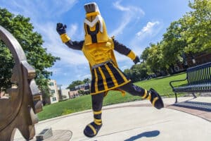 Mascot Manny is jumping in the air