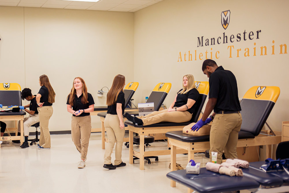 Students in the MAT Lab work collaboratively at multiple benches and stations simulating practices. 