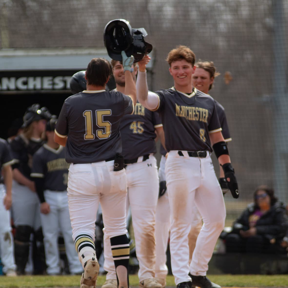 Manchester's team holds helmets high in celebration