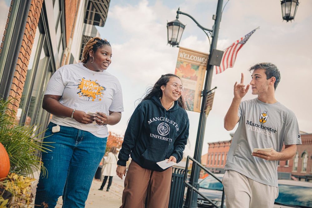 Three MU students pass out window stickers to local area businesses as part of Founder's Day Celebrations
