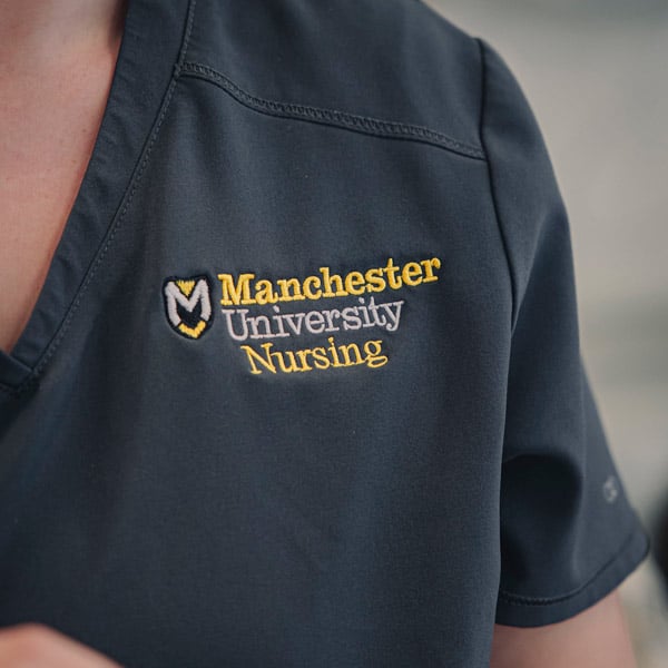 The MU Nursing Logo i visible on the student scrubs.