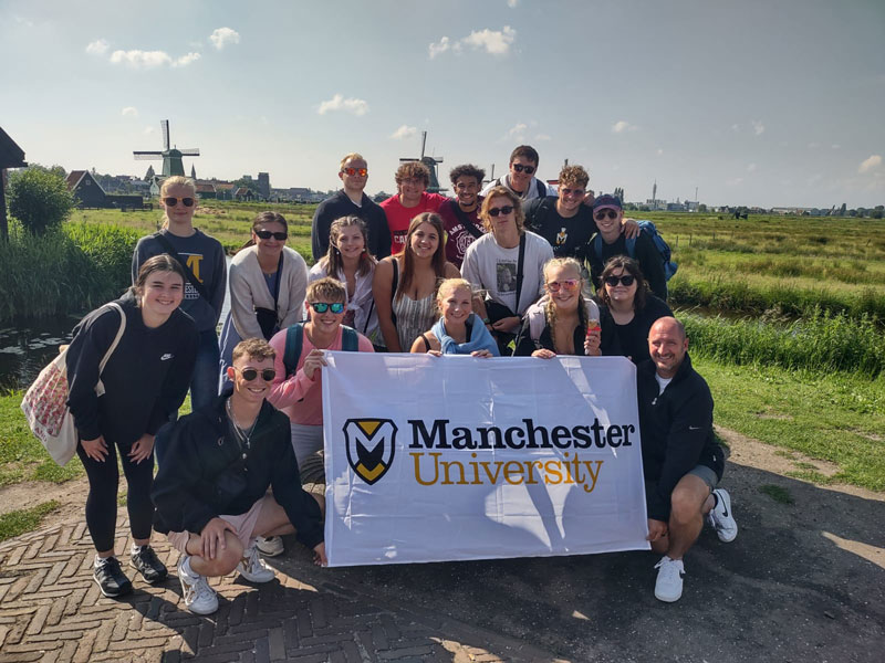 A photo of the study away program in Amsterdam with Windmills in the background