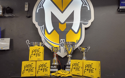 MU Prefire Manchester University esports logo behind boxes of Prefire hand warmers for improved gaming performance.