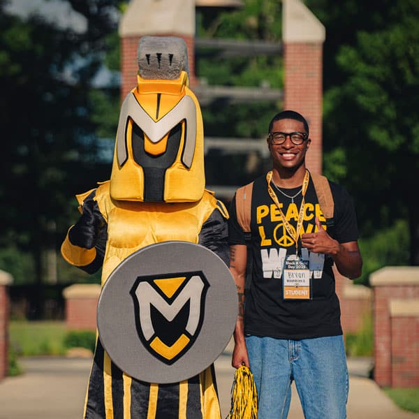 MU new incoming freshman Bryan poses with Manny the Spartan on MU Mall