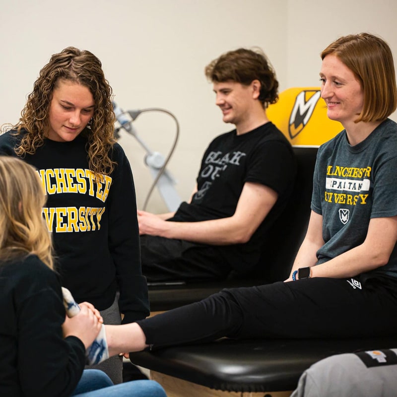The MU Nursing Logo i visible on the student scrubs.