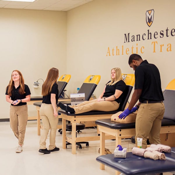 Looking into the eyes during a lab, using a pen light. 